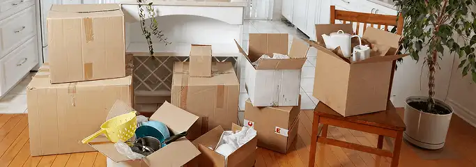 Packed moving boxes and household items in a kitchen before move-out or move-in cleaning, San Jose, CA.